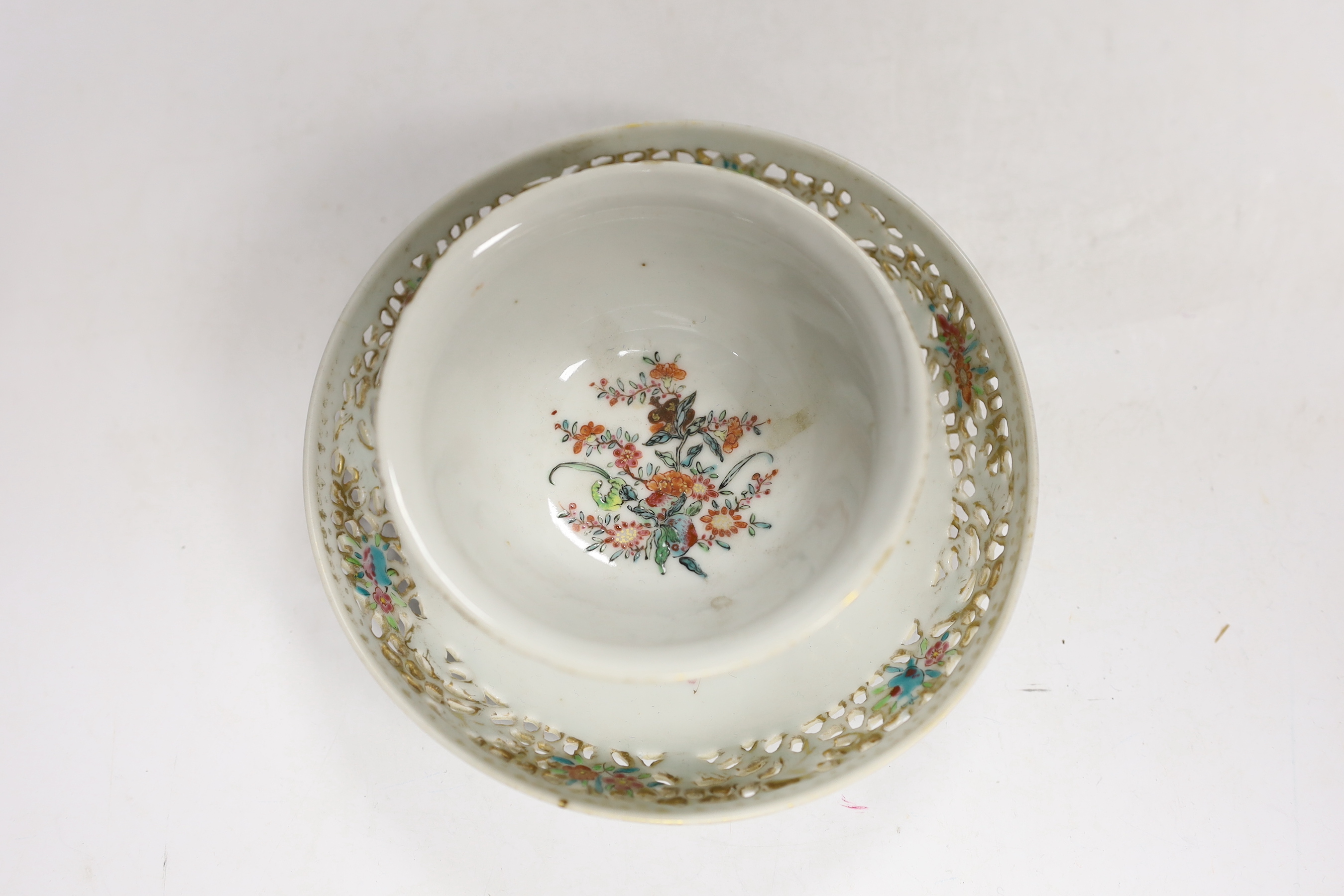 A Chinese 18th century reticulated double walled tea bowl and saucer, two blue and white plates and a jug (5)